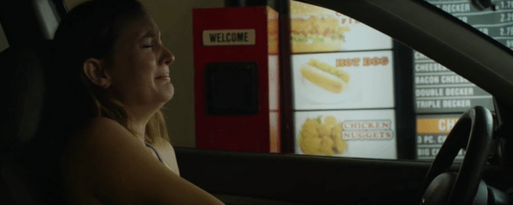 Sasha has a break down in a drive thru. (Photo Courtesy of Magnolia Pictures)